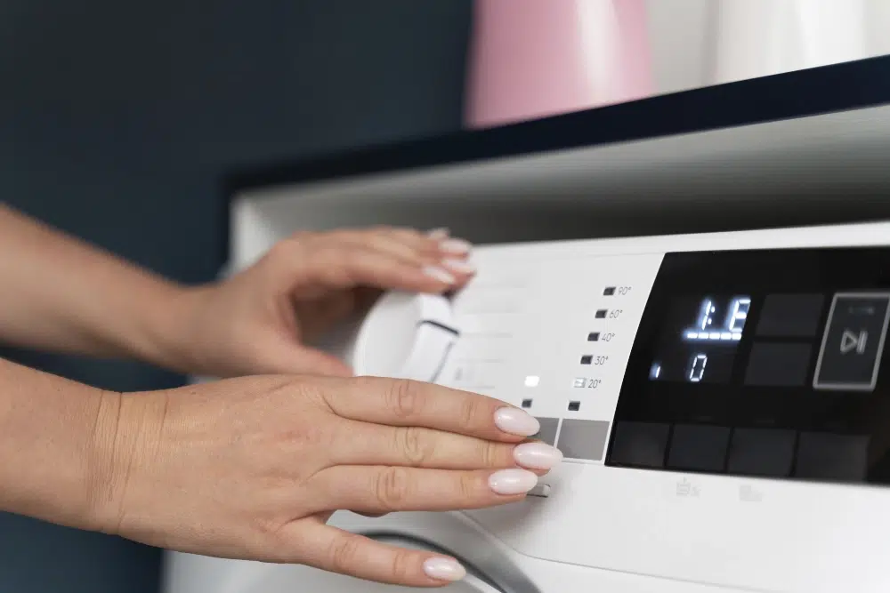 woman-choosing-program-washing-machine